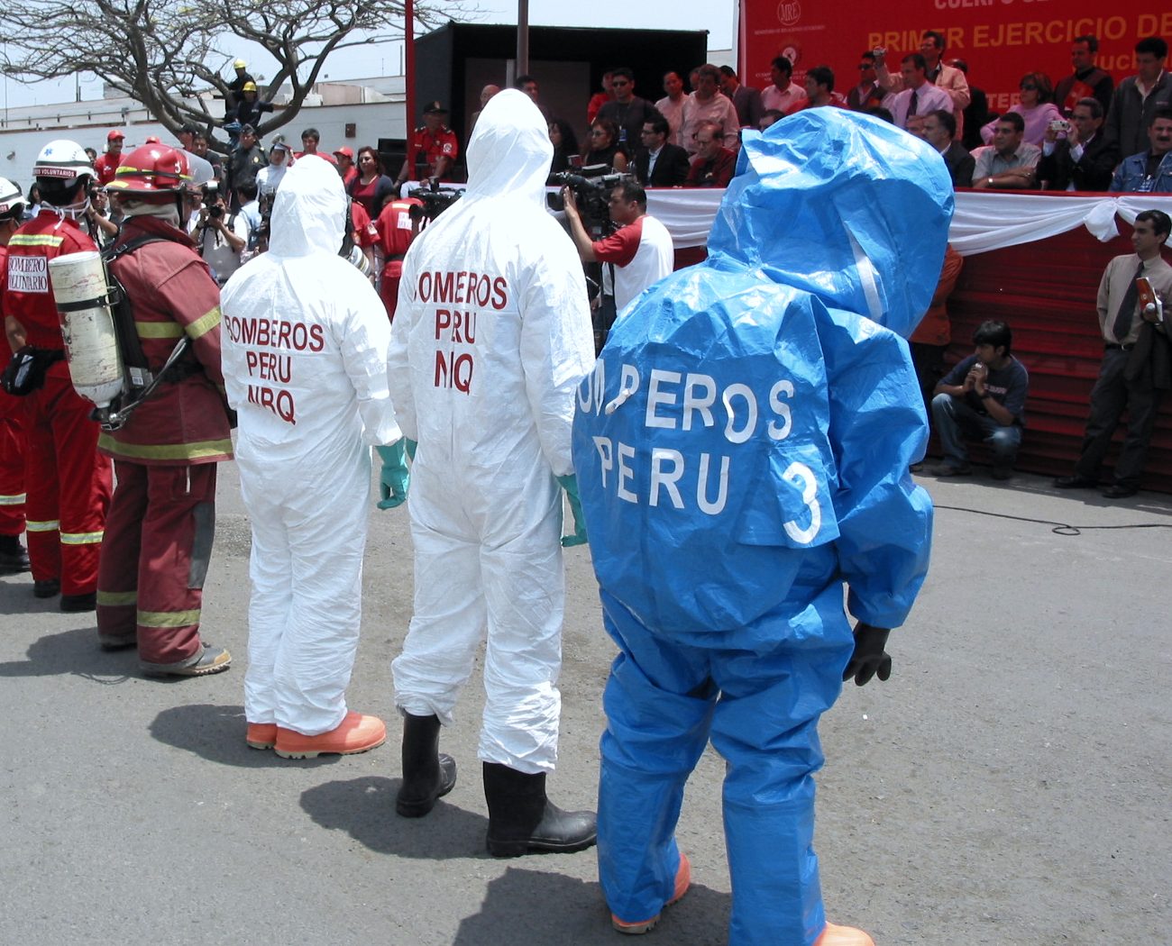 Responders in protective suits lined up for an observed multi-agency exercise